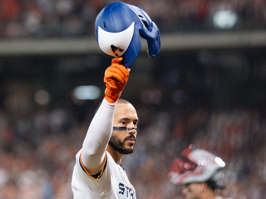 Carlos Correa tips his helmet to the fans after an emotional standing ovation in his first home game back with the Houston Astros. (Photo by F. Carter Smith)