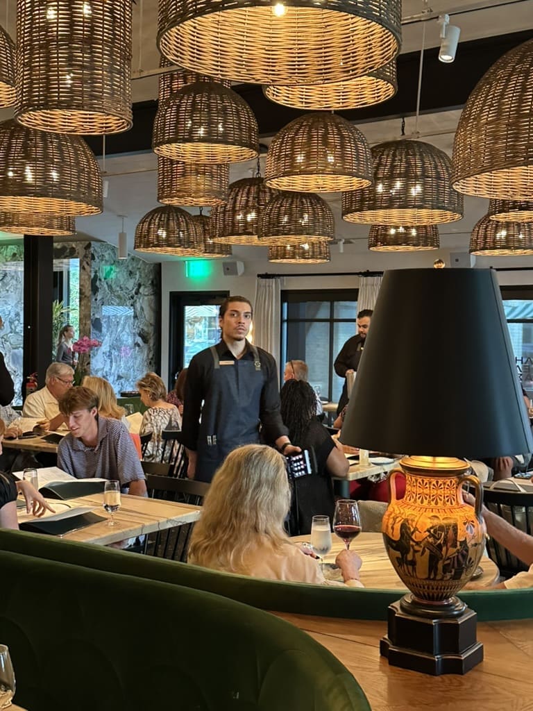 Wicker lamp shades overhead and a lamp replica of Greek antiquities set the stage at Yiayia's Greek Kitchen. (Photo by Shelby Hodge)