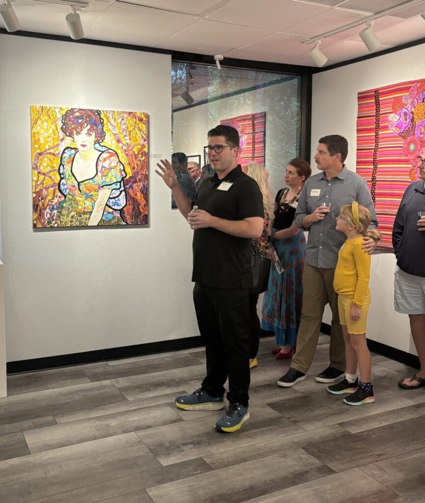 Art educator Ethan Hunt speaks about his pieces in "Lessons in Expression."  He has three pieces included in the show.  (Photo by Laura Landsbaum)