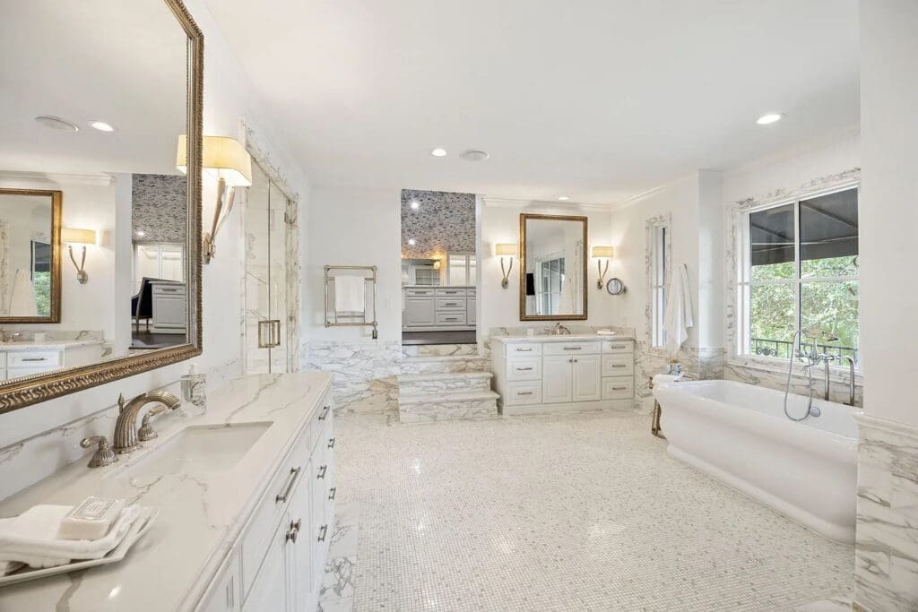 The primary suite's marble spa bath, complete with heated floors and a steam shower. (Photo by Allie Beth Allman & Associates)