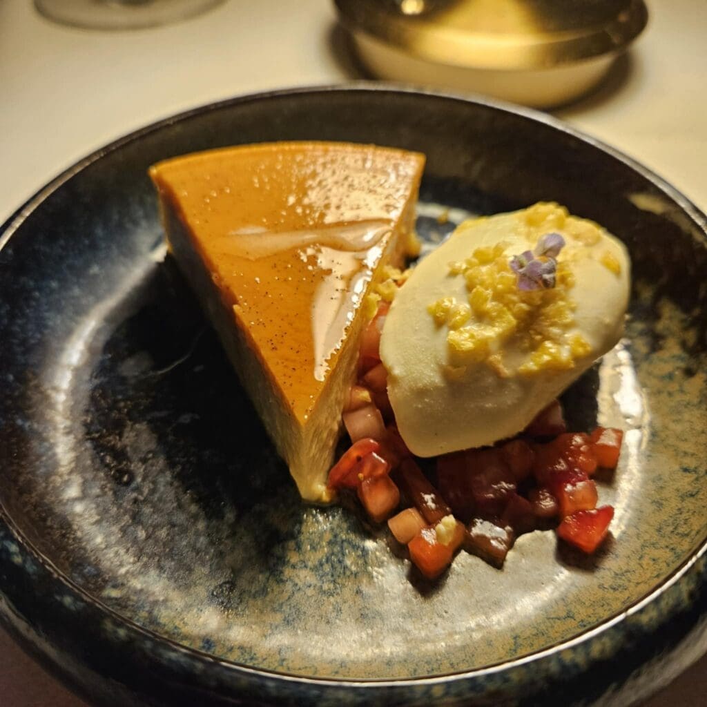 Corn flan at The Crescent Hotel’s Blue Room finished the meal with deep, roasted flavor over smoked olive oil, paired with lavender corn milk ice cream and diced strawberries for a sweet, floral finale. (Photo by Edward Brown)
