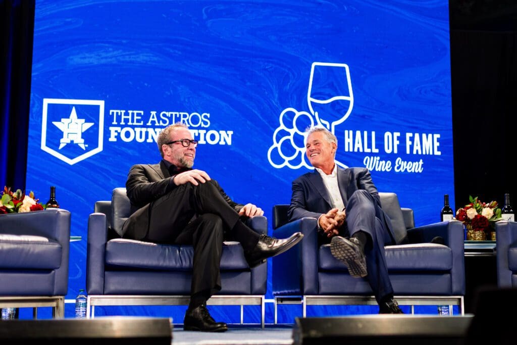 Houston Astro Hall of Fame honorees Jeff Bagwell and Craig Biggio enjoying laughs with Bun B on stage at the Houston Astros Foundation Wine Dinner on the field at Daikin Park. 