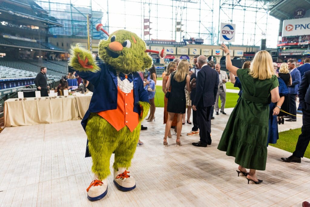 Orbit all dressed up for the Houston Astros Foundation Wine Dinner on the field at Daikin Park. 