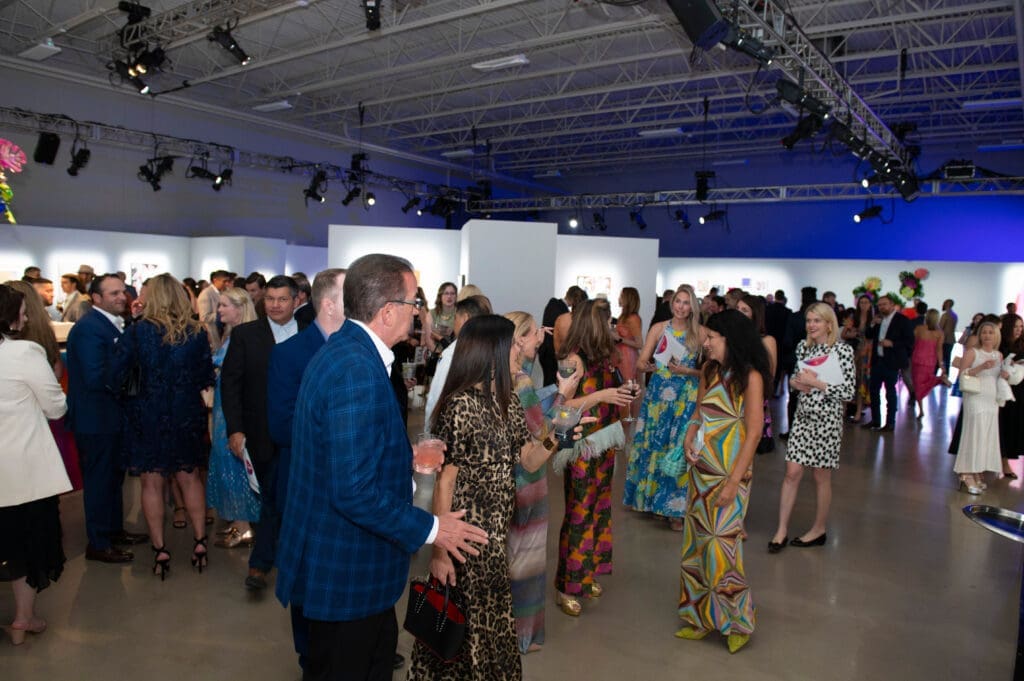 Guests admiring the artwork in the silent auction (Photo by Tamytha Cameron )