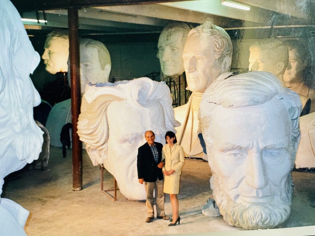 Artist David Adickes with only child Mary Adickes Van Pelt in his Houston sculpture studio with his heroic Presidential series 