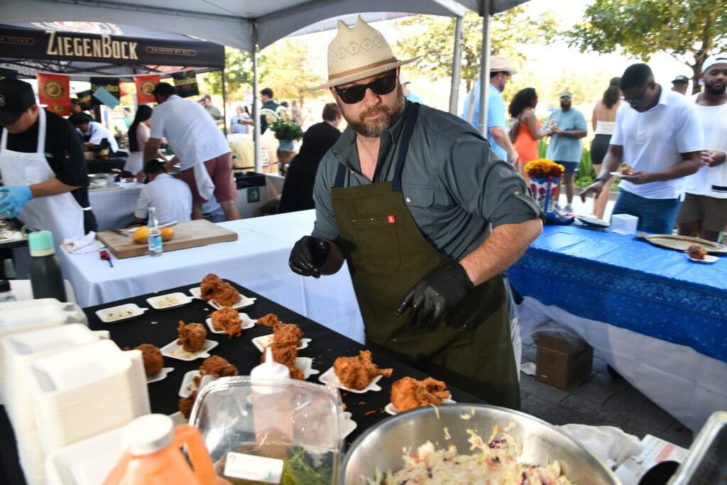 Chef Travis Lenig of Field & Tides works on his Southern Fried Chicken at the Houston Chefs for Farmers (Photo by Dave Rossman)