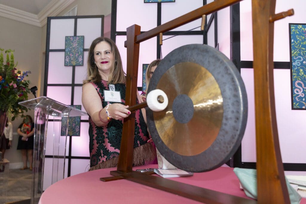 Elizabeth Brhlik sounding the gong for the beginning of the next round (Photo by Sharon Ellman, Ellman Photography)