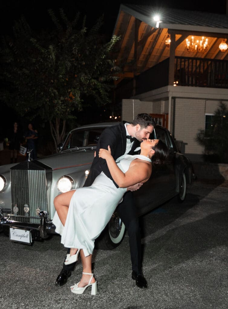 A gorgeous classic auto makes for a stunning backdrop for the classic kiss pose.
