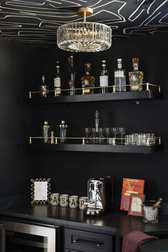 A dark and moody wet bar area makes entertaining easy in the Grogan's Point home.