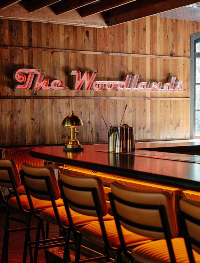 The bar at Local Public Eatery sets the tone for Super Bowl Sunday, with warm wood accents and a neon nod to The Woodlands. (Photo courtesy Local Public Eatery)