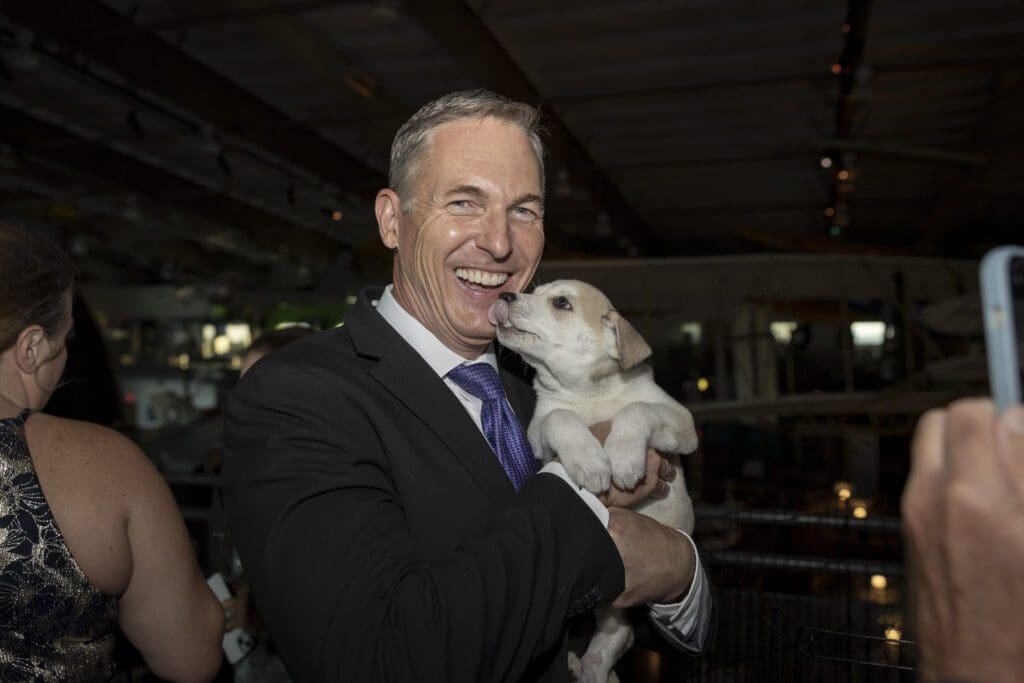 Brian Curtis and a SPCA of Texas puppy (Photo by Thomas Garza)