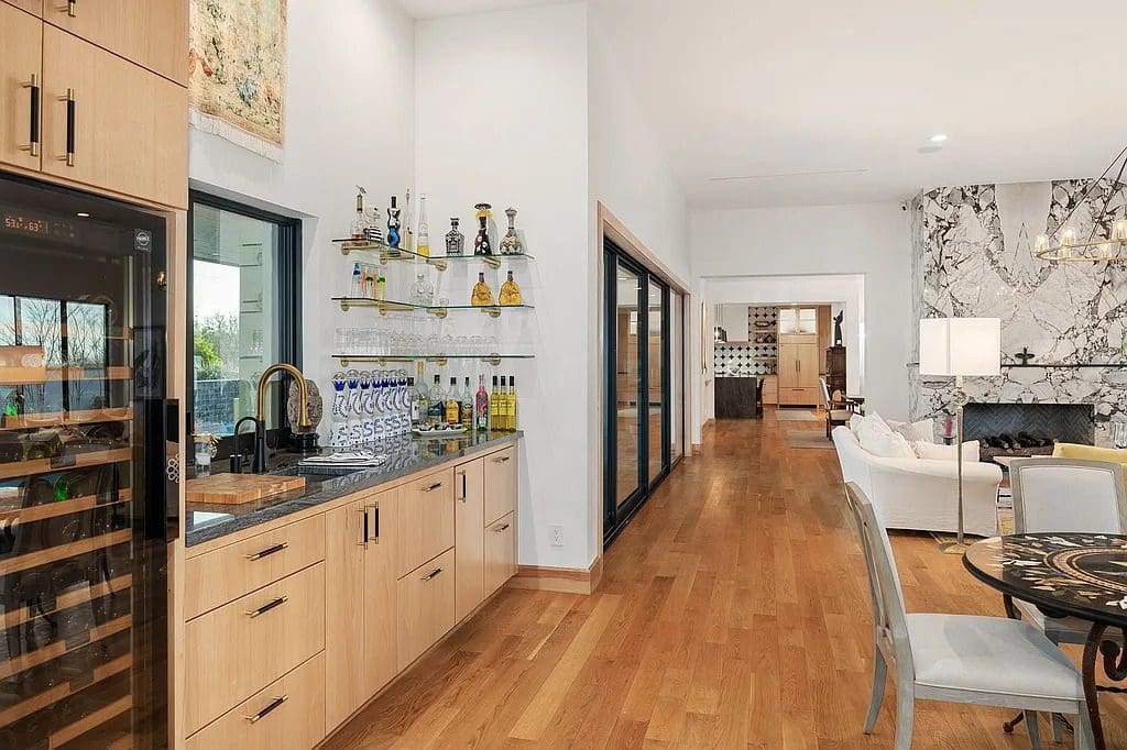 Inside the main residence, light oak floors, natural stone, and open spaces create a balance of warmth and sophistication. (Courtesy)
