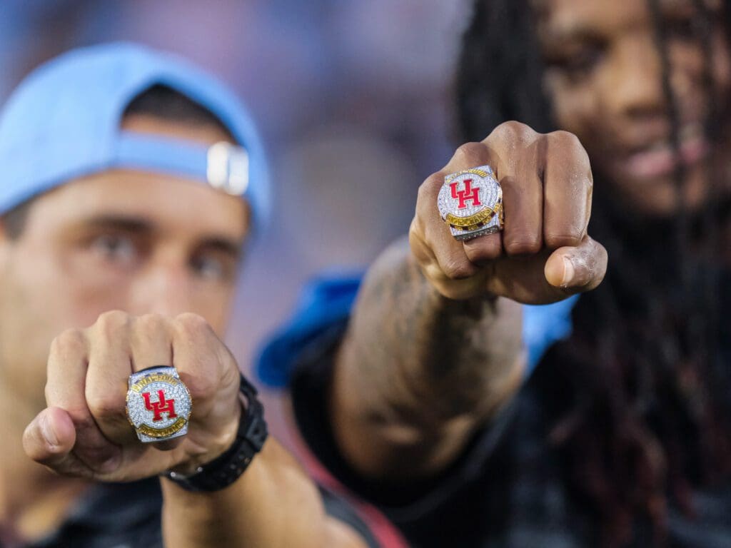 Kellen Sampson and JoJo Tugler show off University of Houston's new championship rings. (Photo by F. Carter Smith)