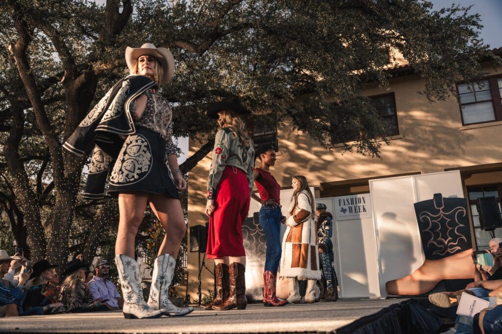 Models made their way down the runway in front of the historic Livestock Exchange Building as golden light filtered through the oaks. (Photo by Avin Park Photography)