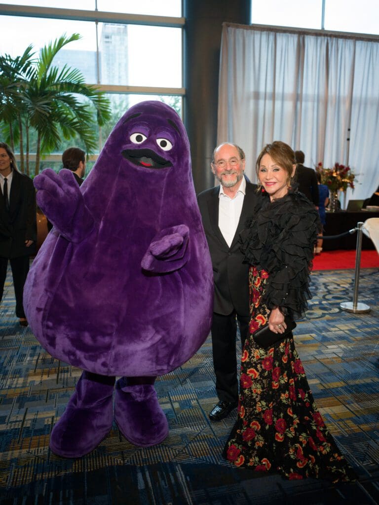 Grimace, Stuart & Gaye Lynn Zarrow at the Ronald McDonald House Charities 'Boo Ball' (Photo by Daniel Ortiz)