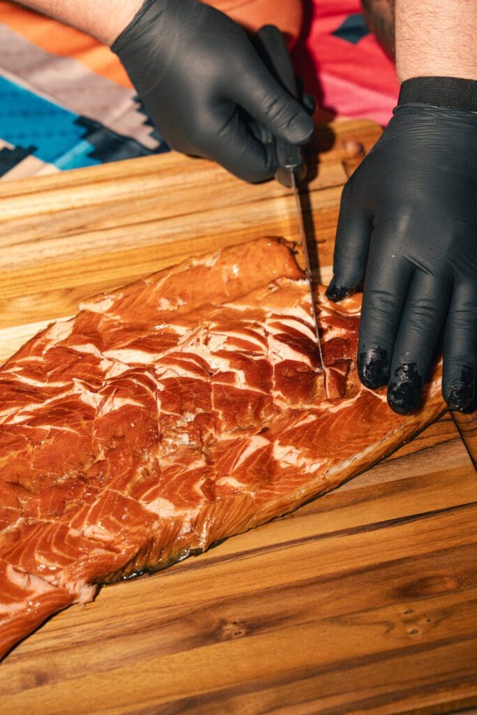 Preparation of Itek Tuchina Three Sisters (salmon with squash, corn, and beans) by chef David Skinner (Photo by Michael Anthony)