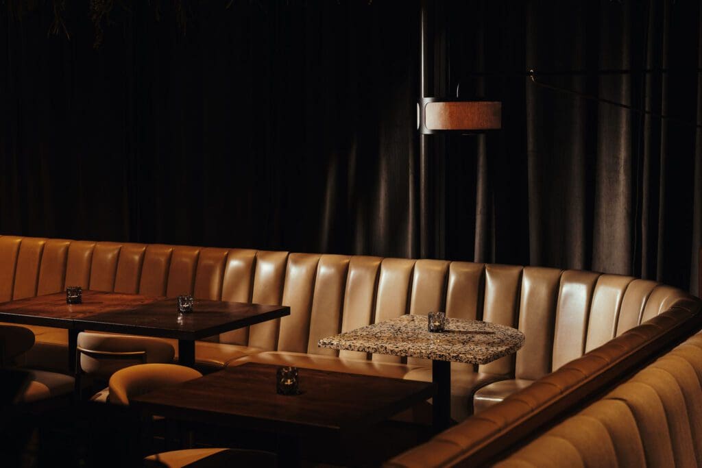Meridian's refreshed interiors include dark velvet green drapery (blocking any sense of the outside world). (Photo by Chase Hall)