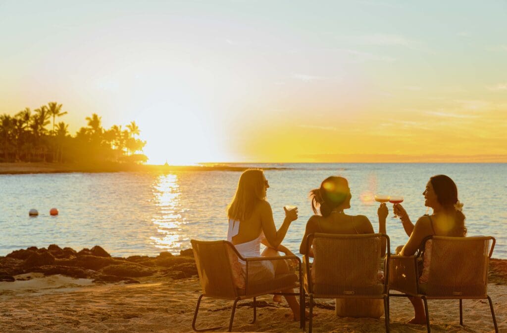 Enjoy pre-dinner cocktails with your toes in the sand (while watching for whales!) at Talk Story Bar, a classic Hawaiian beach bar. (Photo by Kona Village, A Rosewood Resort)