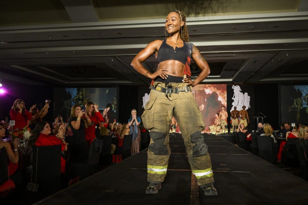 Houston fire fighter Sasha, Ms. September, in the Fire Fighters calendar rocks the runway at the 'Red Hot Gala' (Photo by Catch Light Group)