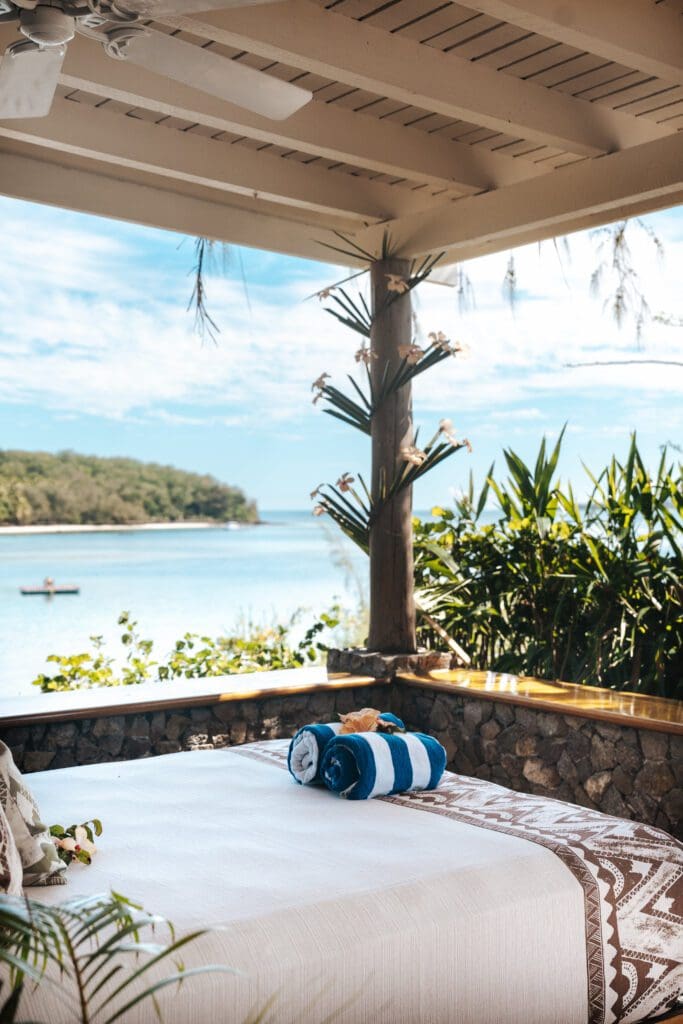 The full size daybed on each bure's porch is perfect for relaxing and enjoying the view of the water.  (Photo by Turtle Island)
