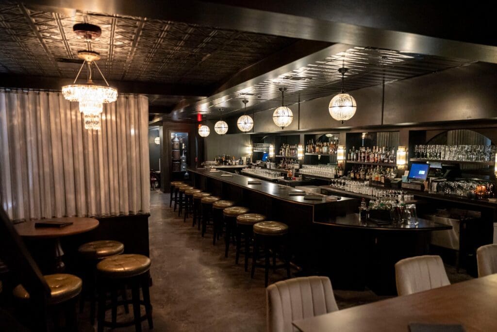 Step behind the bookcase for a Haunted Masquerade & Murder Mystery, where guests in elegant disguise roam four stories of the historic speakeasy, (Courtesy)