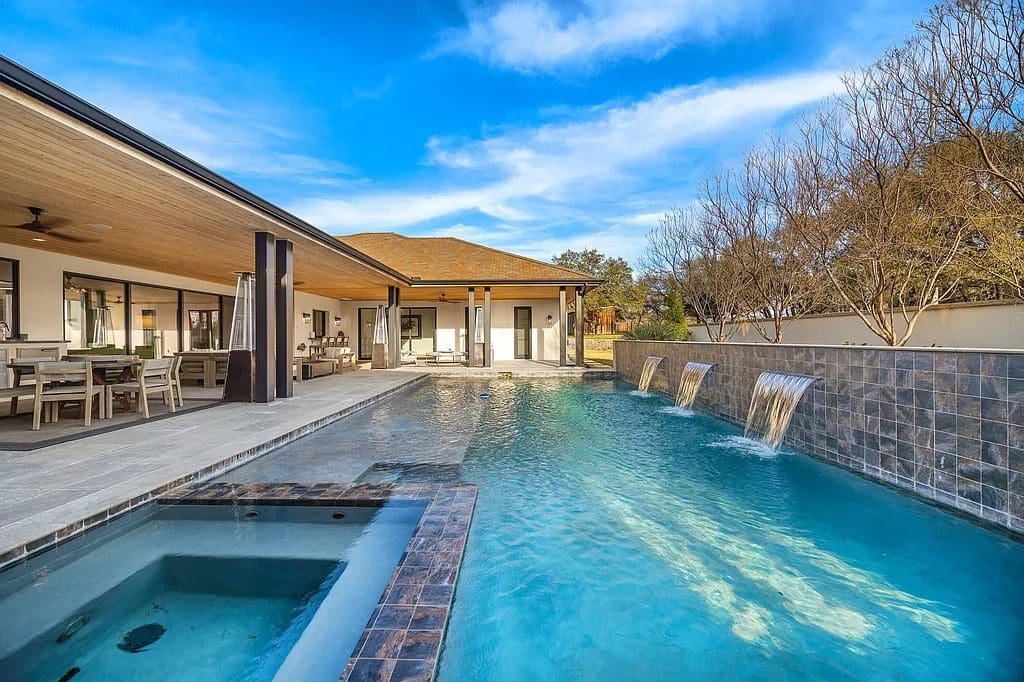 Outdoor living takes center stage with a heated pool, spa, and covered patio designed for year-round entertaining. (Courtesy)