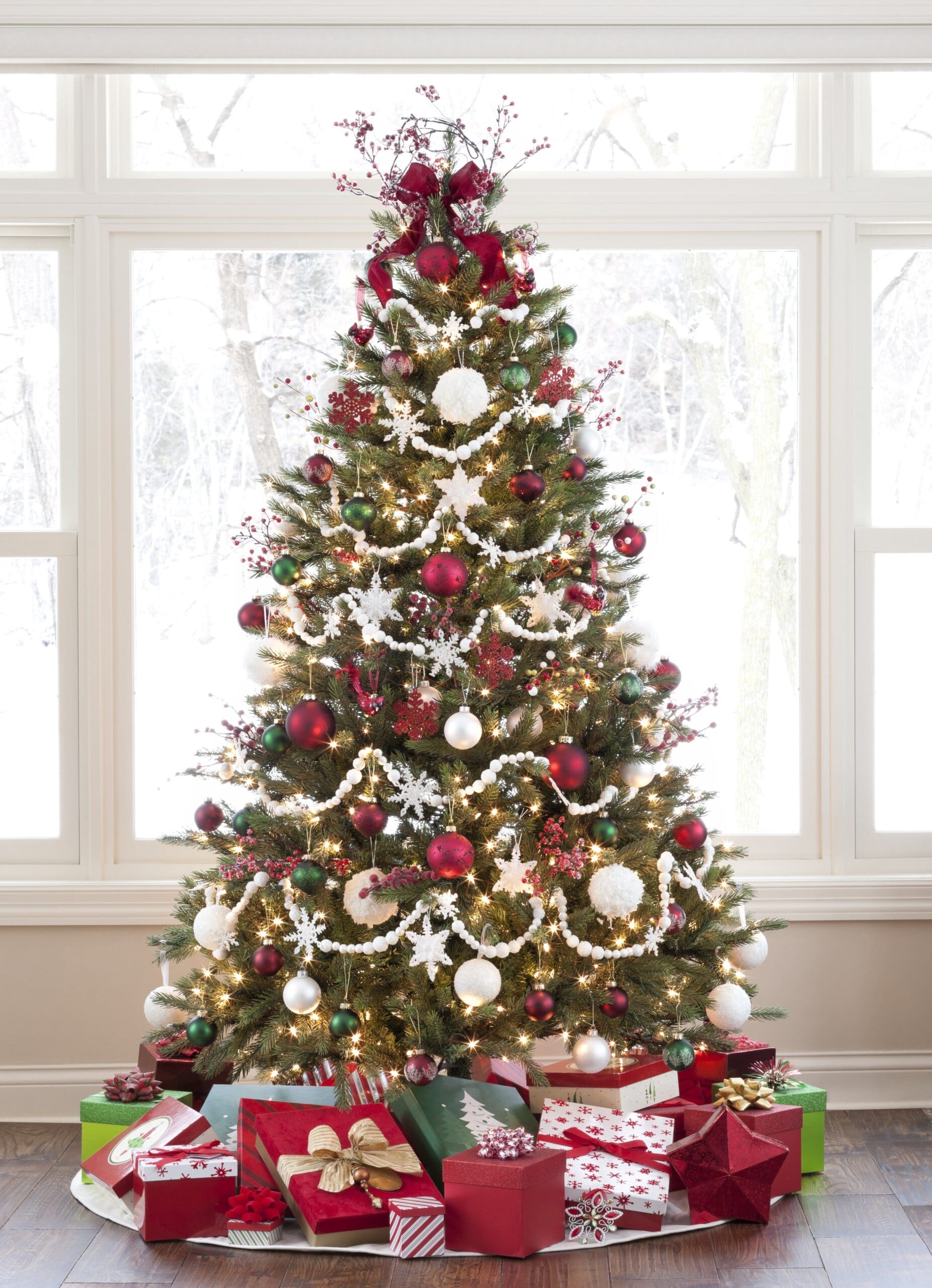 Christmas Tree with Ornaments and Gifts against a Picture Window