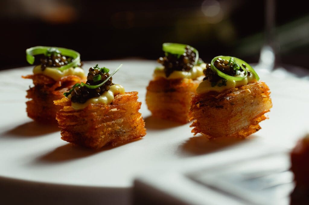 Discover refined, indulgent bar fare layered with dark, decadent ingredients alongside cocktails unveiled tableside with jewel-like garnishes and unexpected fusions.