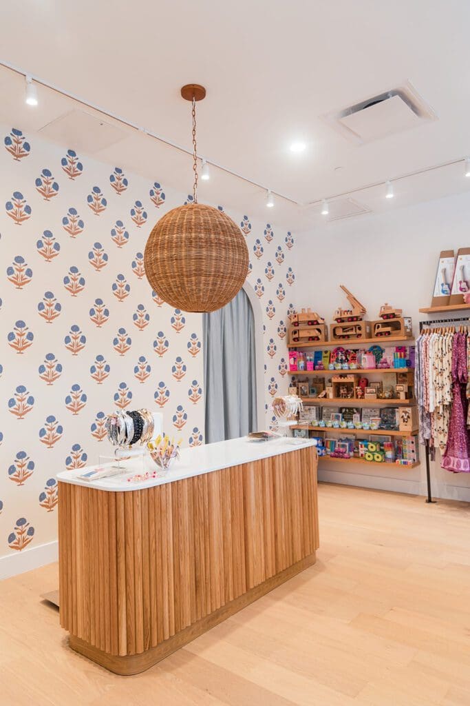 The Pink Chicken store uses the brand's signature block print as wallpaper in the store. (Photo by Siena Photography)