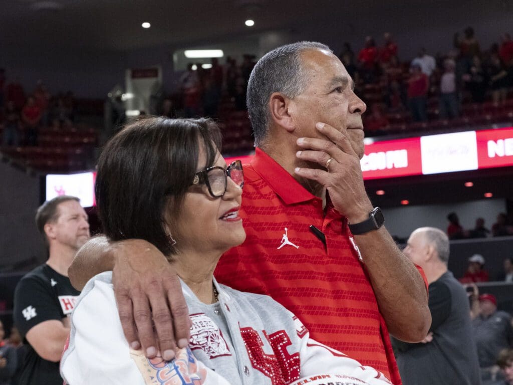University of Houston coach Kelvin Sampson put his arm around Karen Sampson, his wife of 46 years, during the video tribute to his 800 wins. (Photo by F. Carter Smith)