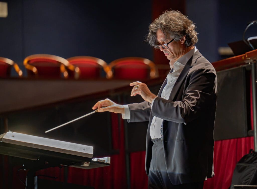 Jorge Parodi conducting at the dress rehearsal for Tom Cipullo's "Hobson's Choice," world premiere at the Moores School of Music