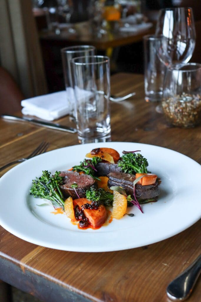 Clay Pigeon’s Winter Prix Fixe menu showcases dishes like Hamachi crudo, wood-grilled venison and an “Old Fashioned” cake crafted by the From Scratch Hospitality team. (Courtesy)