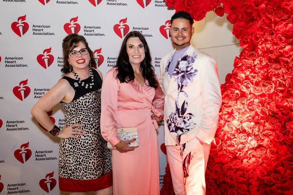 Melody Torno, emcee Cheryl Mercedes, Dion Bart at the Elizabeth Anthony 'Go Red for Women' fashion event (Photography by Christina Griffin, WDR Imagery)