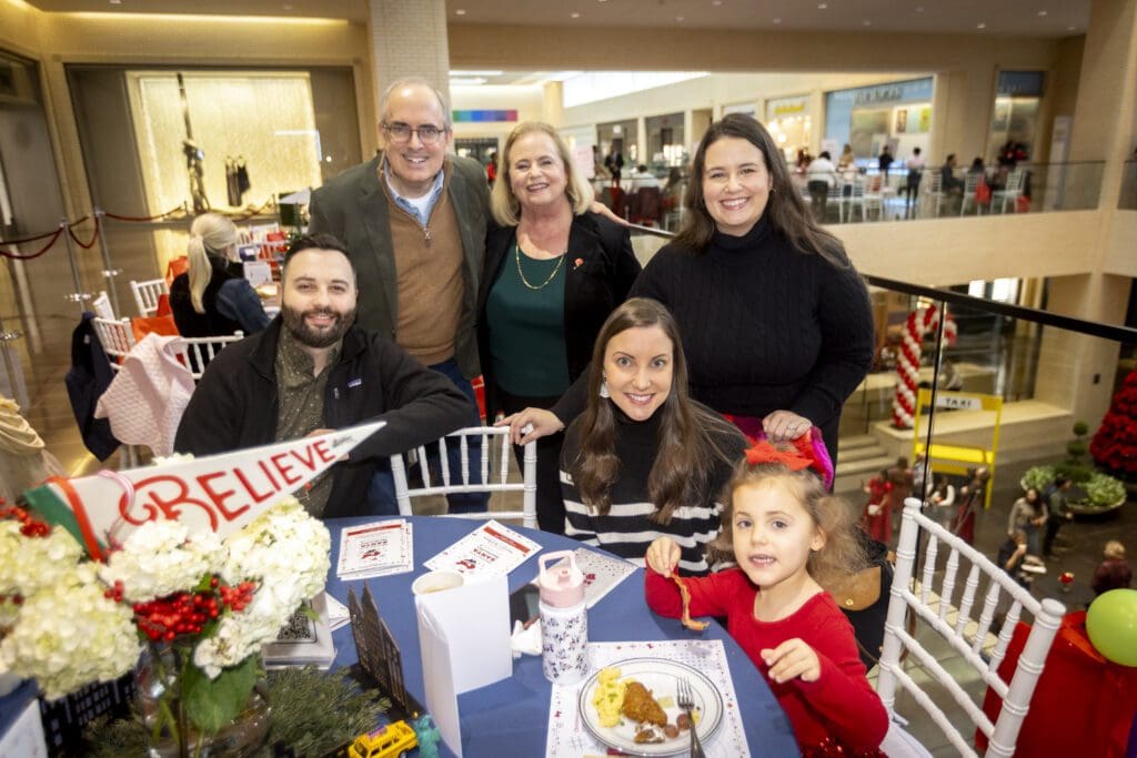 Brent Christopher, Children’s Medical Center Foundation President, with CMCF Board President Rebecca Egelston Caso and her family (Photo by Kim Gleason)