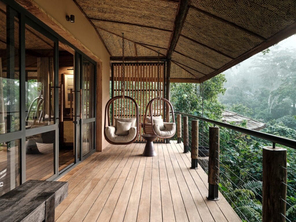 Guiet moments on patio swings listing to the forest sounds watching red-tailed monkeys pass by is a sacred activity at Gorilla Forest Lodge