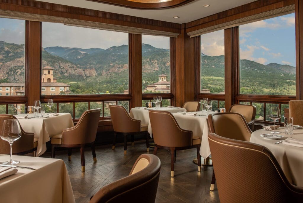 The Penrose Room offers a golden hour panoramic view of Cheyenne Mountain. (Photo by The Broadmoor)
