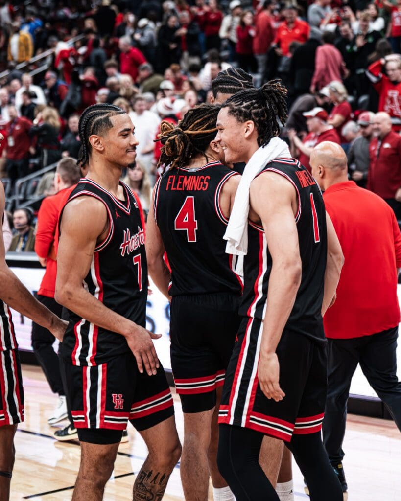 University of Houston guards Milos Uzan and Isiah Harwell celebrate the win over Arkansas. (@UHCougarMBK)