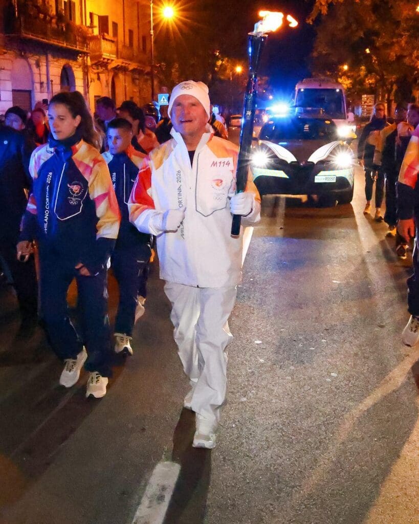 US Ambassdor to Italy Tilman Fertitta joins the Olympic torch relay in Palmero, Sicily, donning the uniform running suit and jogging through the town. (Courtesy photo)