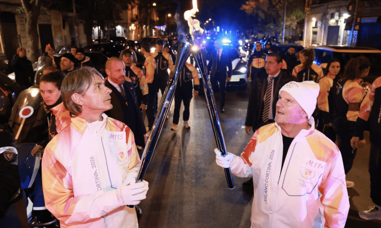 United States Ambassador to Italy Tilman Fertitta passes the Olympic torch to Italian soccer icon Filippo Inzaghi during the Olympic relay in Sicily. (Olympic.com photo)