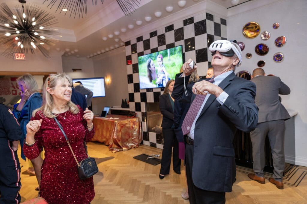 Sherry & Ron Noblett dip into VR at the Ambassadors for Texas Children’s Hospital Houston Holiday Party   (Photo by Jenny Antill/Texas Children's Hospital)
