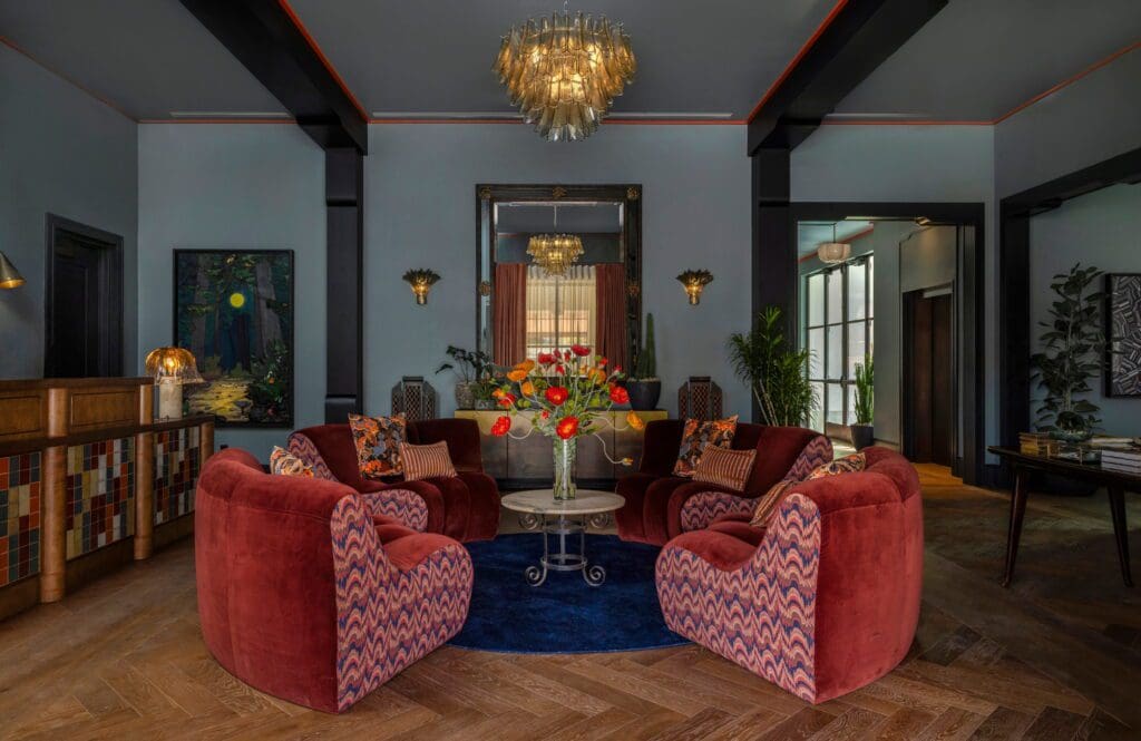 In the lobby, a circular vintage sofa found in Round Top is covered in Pierre Frey and Nobilis fabrics. Murano chandelier with rondini glass. (Photo by Julie Soefer)