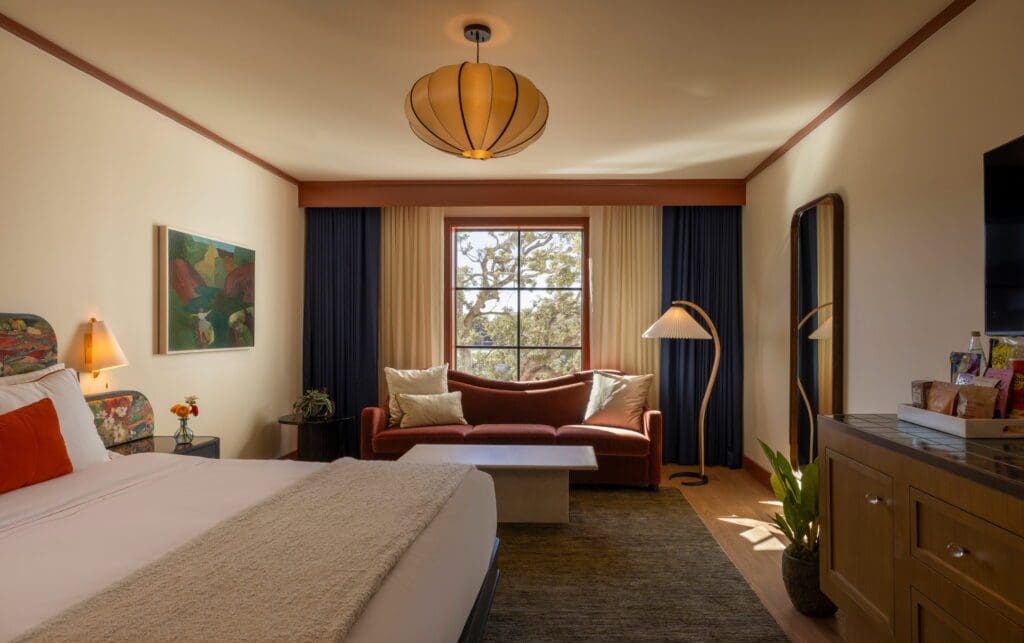 In a guest room, mohair seating and an Arts and Crafts style credenza. (Photo by Julie Soefer)