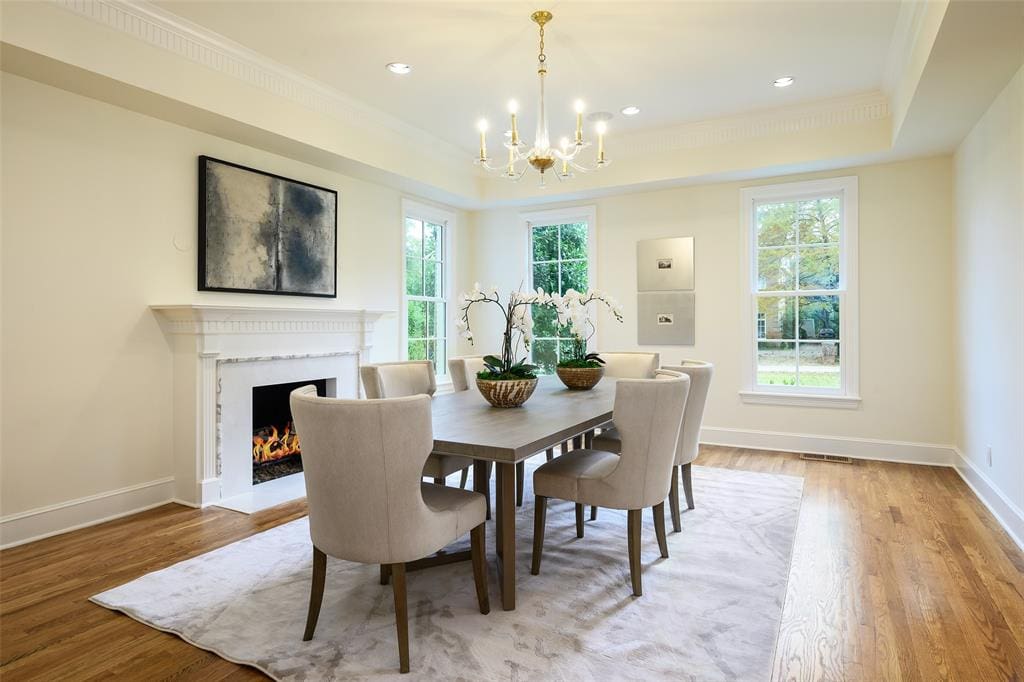 In the traditional layout, a formal living room and formal dining room flank the foyer, with mirroring fireplaces. (Photo by Compass RE Texas, LLC)