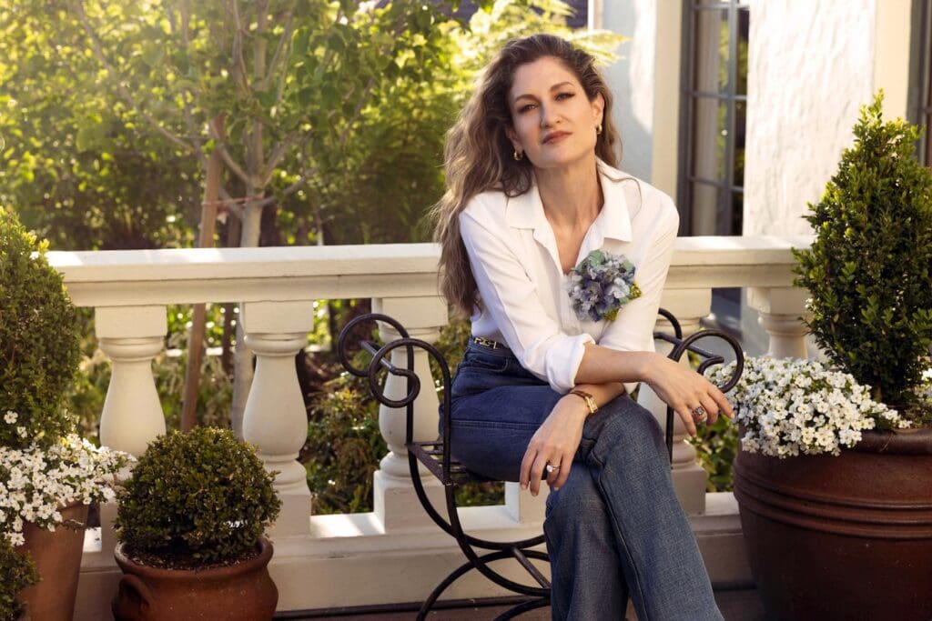 Helena Simon wears Blue Hydrangea from her namesake collection of  fabric floral brooches, all handmade. 