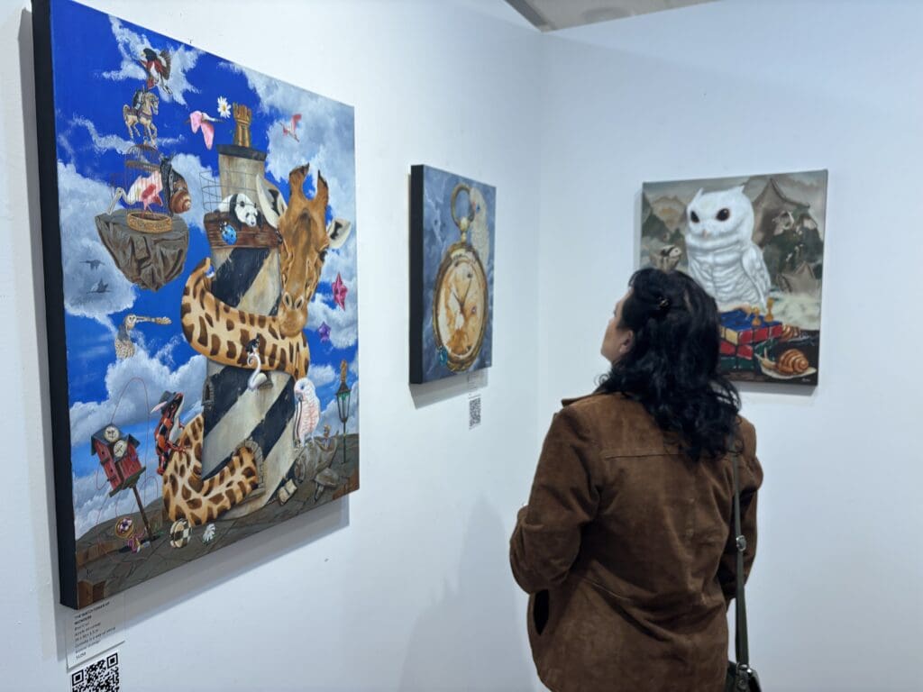Each painting in the exhibit features a Goffin cockatoo which acts as the unifying thread for the series. (Photo by Laura Landsbaum)