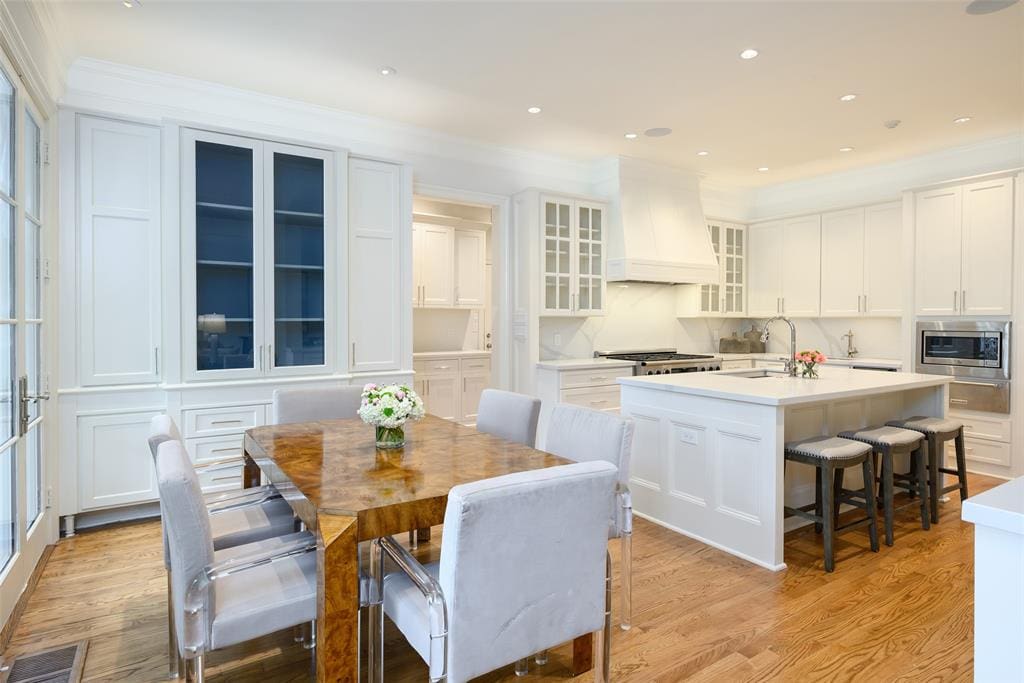 The dining room and family room flow into the gourmet kitchen. (Photo by Compass RE Texas, LLC)