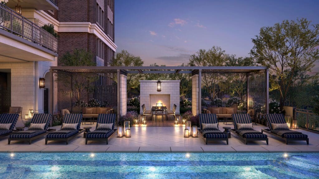 A garden view of The Langley pool deck with fireplace and pergolas.