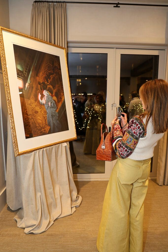 Kara Childress viewing images at Christiana Reckling's debut photography show (Photo by Mia Bonner Photography)