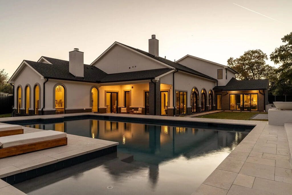 The resort-style backyard features a striking pool, complemented by fountains. (Photo by Compass RE Texas, LLC)
