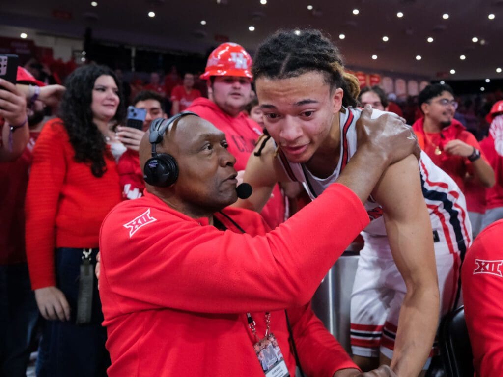 University of Houston legend Elvin Hayes pulled freshman point guard Kingston Flemings into an embrace. (Photo by F. Carter Smith)